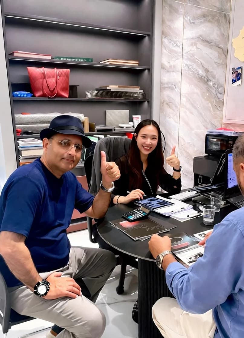 A visiting group seated in the showroom meeting area