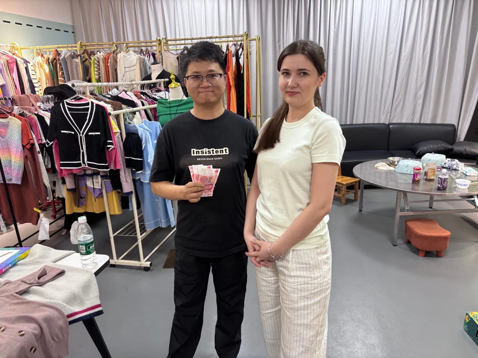 Visitors with our merchandising team in front of the showroom sample rail